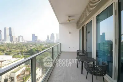 Spacious balcony with stunning city view and modern seating area.