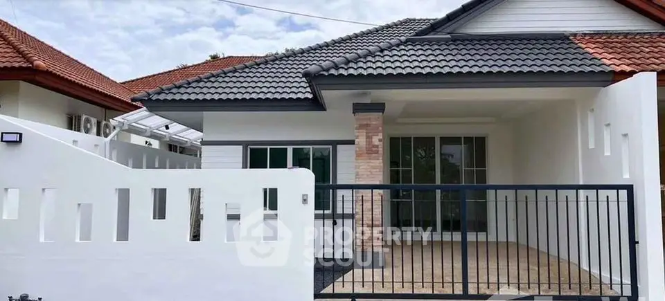 Charming single-story house with tiled roof and spacious front patio