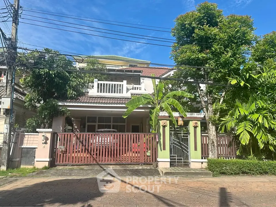 Charming suburban house with lush greenery and spacious front yard, perfect for family living.