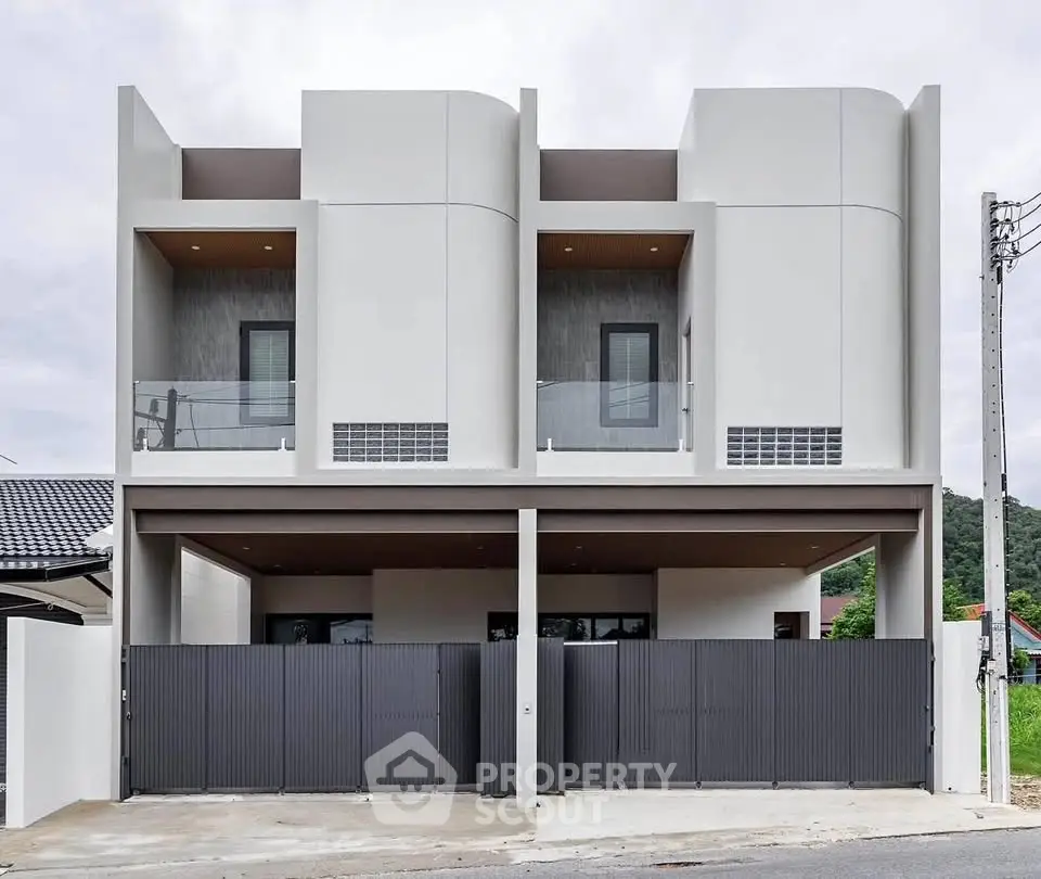 Modern duplex exterior with sleek design and gated entrance, perfect for contemporary living.