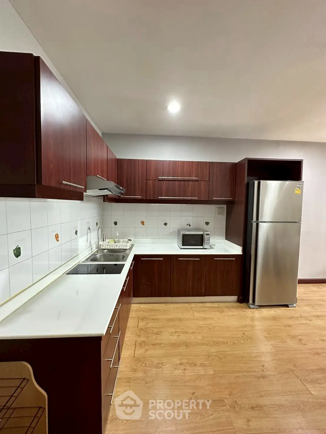 Modern kitchen with sleek wooden cabinets and stainless steel appliances
