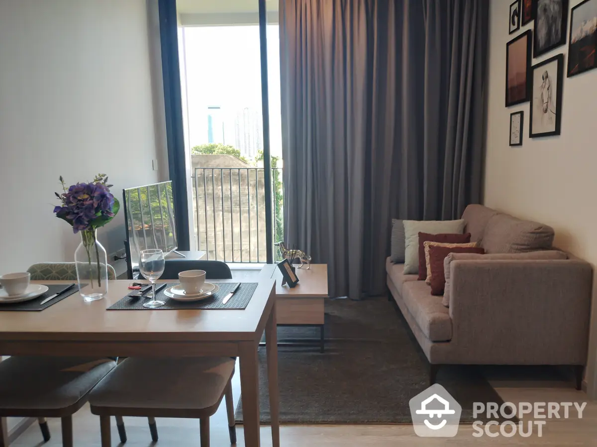 Elegant living room with natural light streaming in from balcony, modern furniture, and tasteful wall art, perfect for urban living.