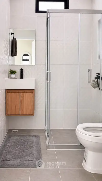 Modern bathroom with sleek shower enclosure and stylish vanity unit.
