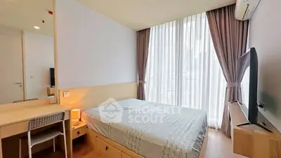 Modern bedroom with large window, stylish decor, and natural light.