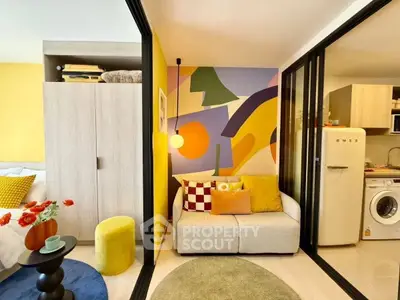 Chic modern apartment with colorful decor and compact layout, featuring a cozy living area and stylish kitchen.