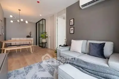 Modern living room with stylish decor and dining area in open layout apartment.