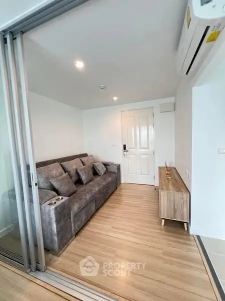 Modern living room with sleek design and comfortable sofa in a cozy apartment.