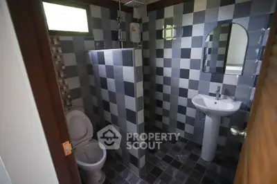 Modern bathroom with checkered tiles and sleek fixtures