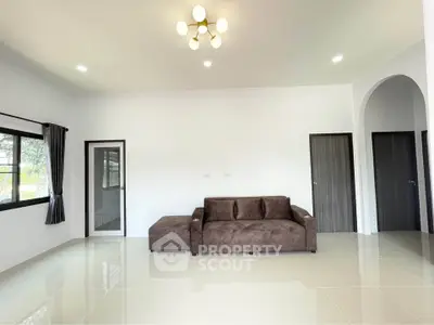 Spacious modern living room with elegant sofa and stylish lighting
