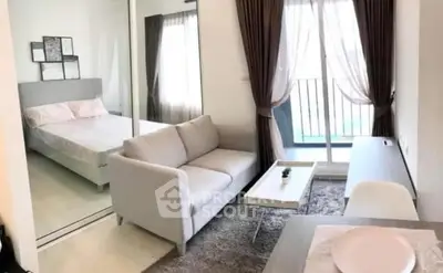 Modern studio apartment with cozy living area and bedroom, featuring a balcony view.