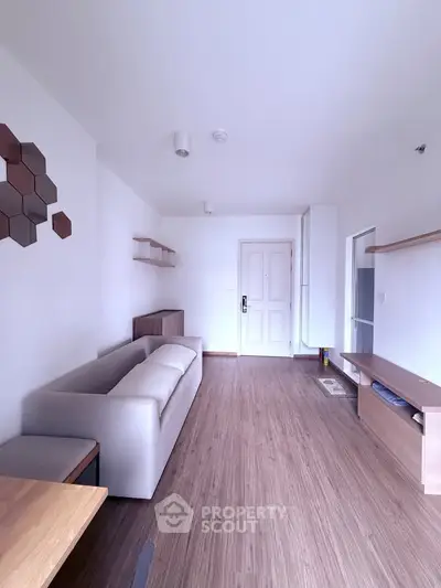 Modern living room with minimalist decor and wooden flooring