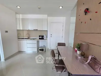 Modern kitchen and dining area with sleek design and contemporary furnishings.