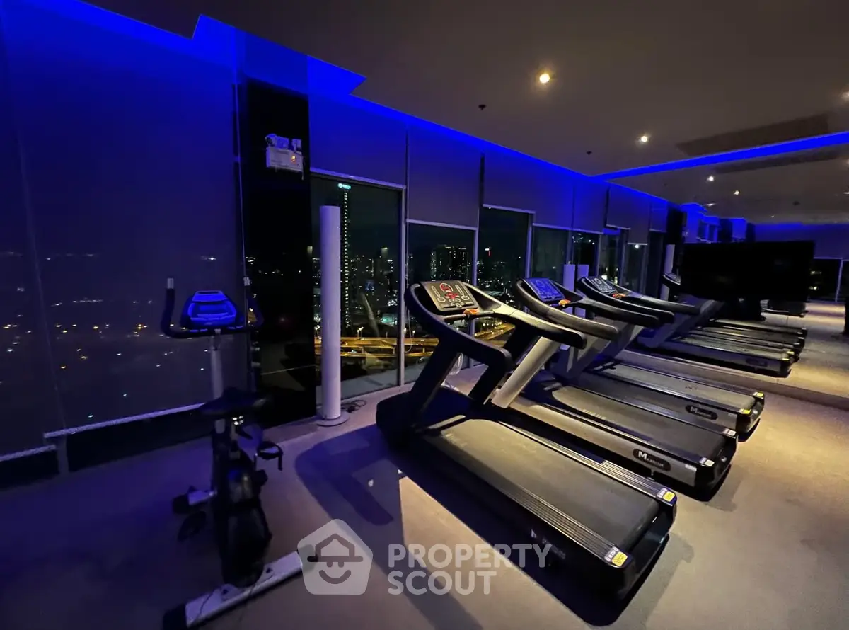Luxurious high-rise gym with city view and modern equipment