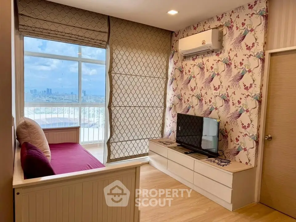 Charming living room with city view, stylish wallpaper, and cozy seating area.
