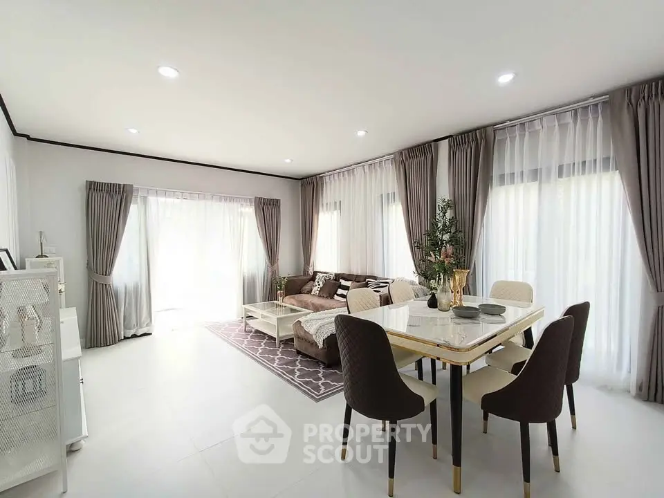 Spacious modern living room with elegant dining area and natural light