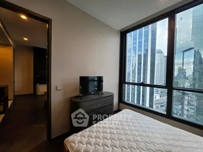 Modern bedroom with city view in high-rise apartment