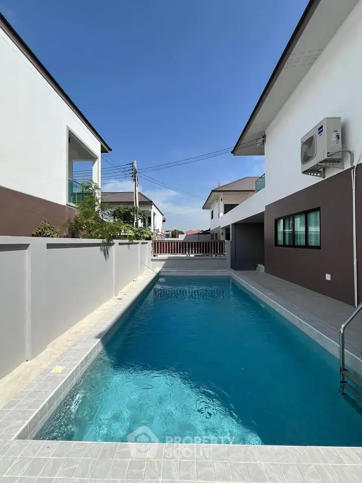 Modern residential property with sleek swimming pool and contemporary architecture.