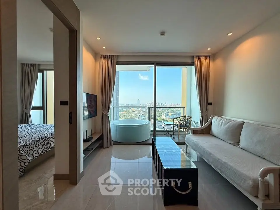 Modern living room with city view and balcony access, featuring a cozy sofa and stylish decor.