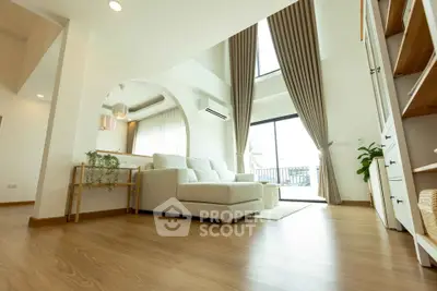 Spacious modern living room with high ceilings and elegant decor
