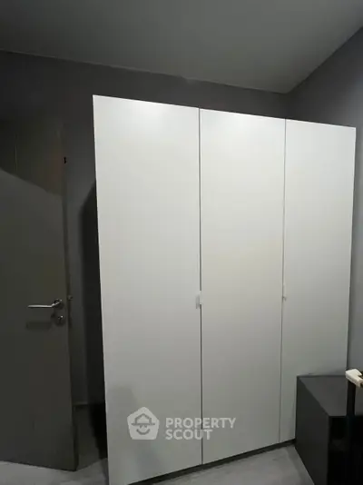 Modern minimalist wardrobe in a sleek interior space with neutral tones.