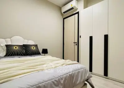 Modern bedroom with stylish decor and air conditioning in a cozy apartment.