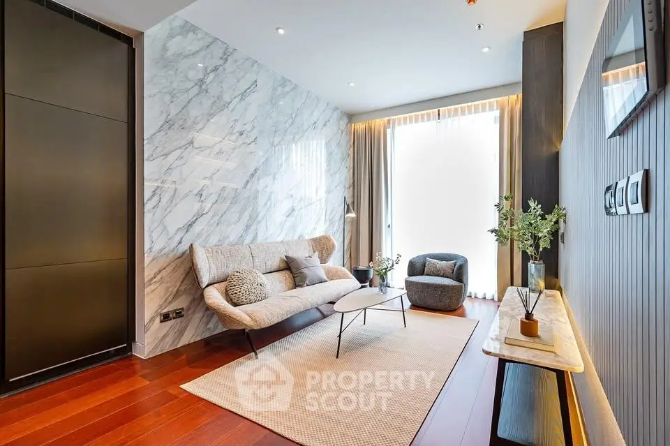 Luxurious modern living room with marble accent wall and elegant furnishings.