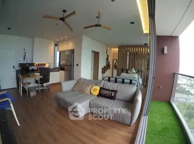 Modern open-plan living room with stylish decor and city view balcony
