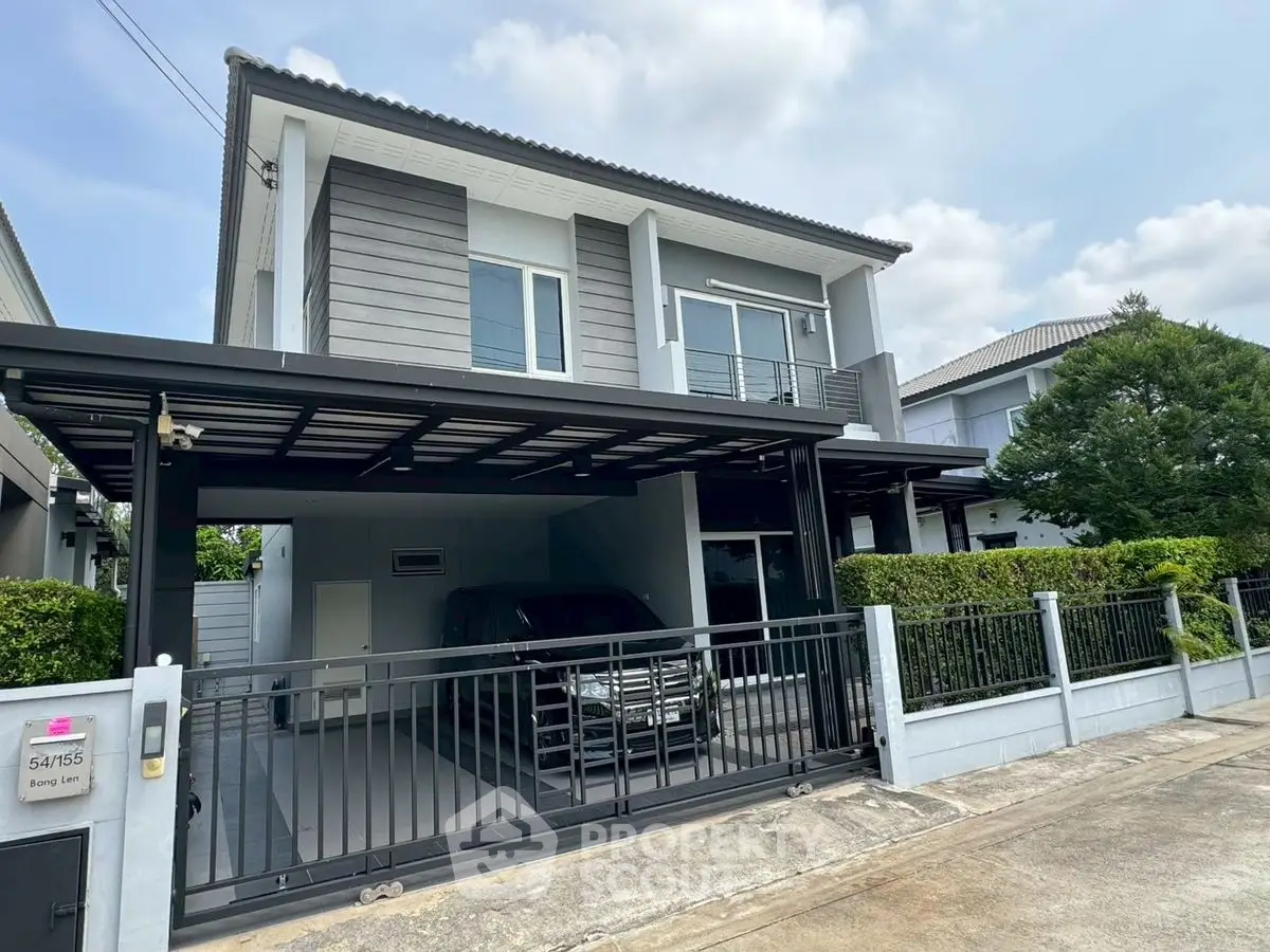 Modern two-story house with spacious driveway and sleek exterior design.