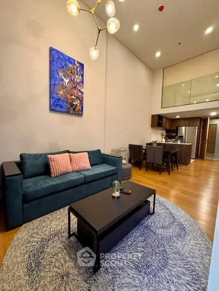 Modern living room with high ceiling and stylish decor in a cozy apartment.