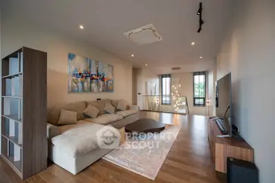 Spacious modern living room with stylish decor and large windows