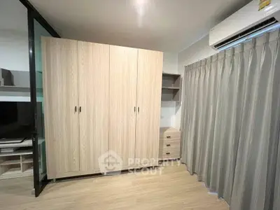 Modern bedroom with sleek wardrobe and air conditioning unit