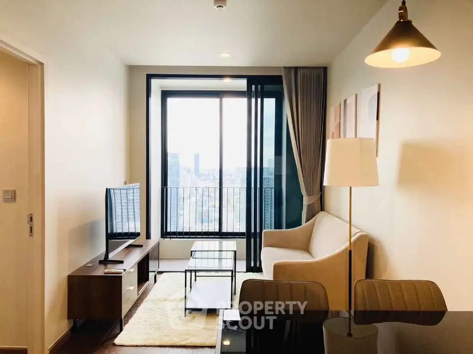 Modern living room with city view, stylish furniture, and large window for natural light.