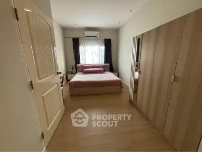 Spacious bedroom with modern furnishings and ample natural light