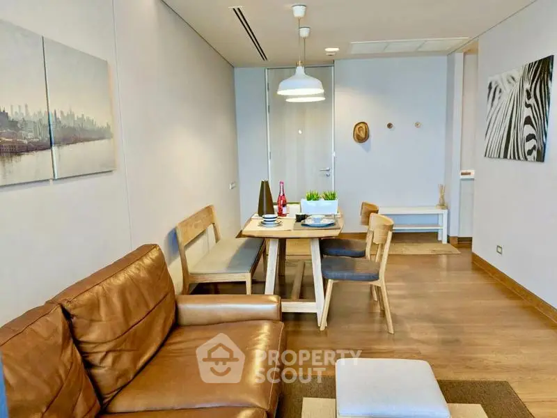 Modern living room with stylish dining area and cozy leather sofa, perfect for urban living.