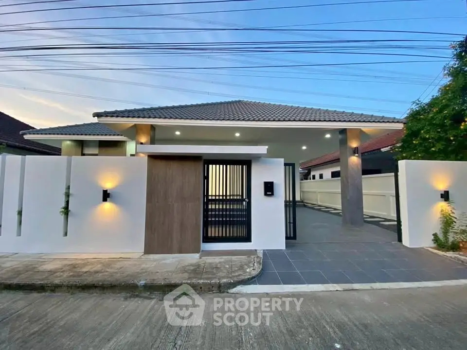 Modern single-story house with sleek design and gated entrance, perfect for contemporary living.
