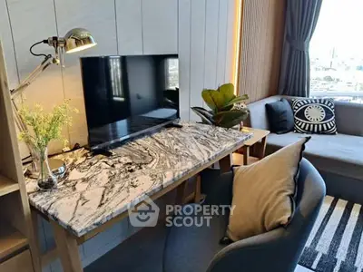 Modern living room with stylish marble desk, cozy seating, and city view window.