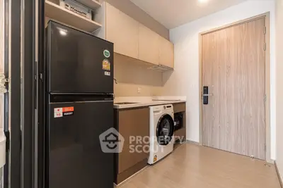 Modern kitchen with sleek appliances and wood accents in a stylish apartment.
