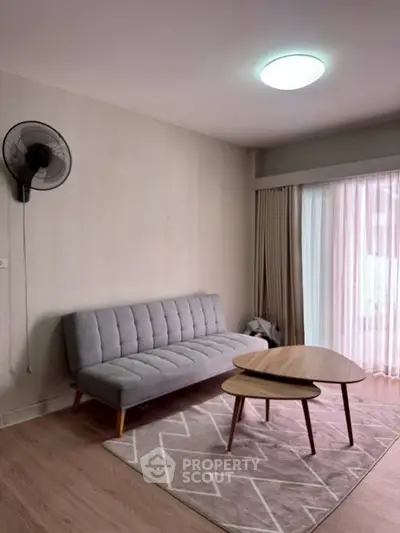 Cozy living room with modern sofa and stylish coffee table, perfect for relaxation.