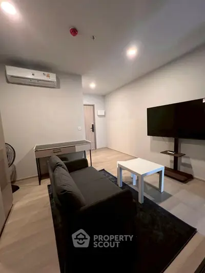 Modern living room with sleek furniture and wall-mounted TV, perfect for cozy relaxation.