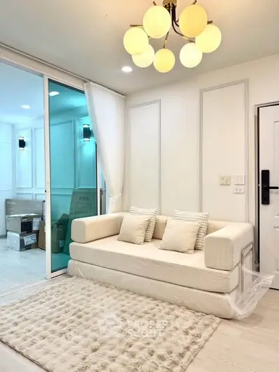 Elegant living room with modern sofa and chic lighting in a stylish apartment.