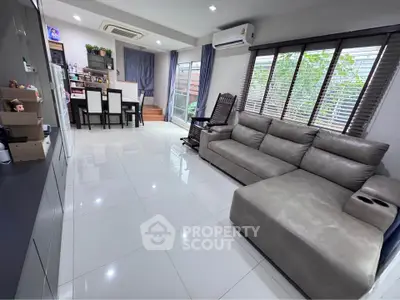 Spacious modern living room with large windows and elegant furniture, perfect for family gatherings.