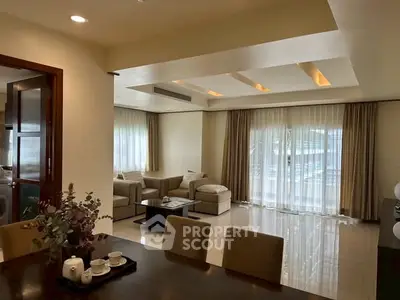 Spacious living room with elegant decor and large windows for natural light.