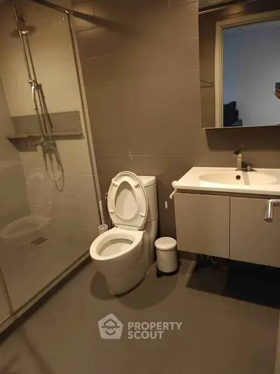 Modern bathroom with sleek fixtures and glass shower enclosure