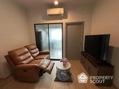 Cozy living room with leather sofa and modern TV setup