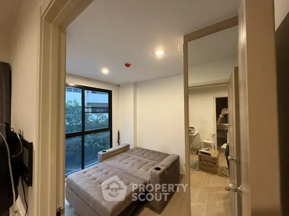 Modern bedroom with convertible sofa bed and large window view