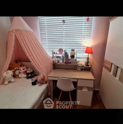 Charming children's bedroom with cozy canopy bed and study desk, perfect for a playful and productive space.