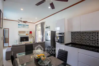 Modern open-plan living room and kitchen with sleek design and stylish decor.