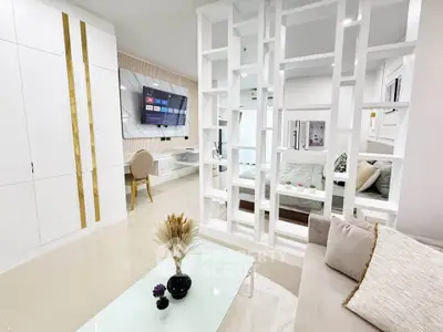 Modern living room with stylish partition and cozy decor in a contemporary apartment.