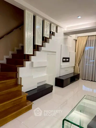 Modern living room with stylish staircase and elegant decor
