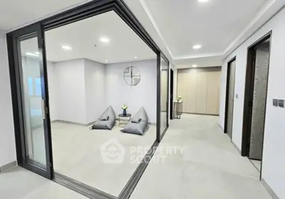 Modern interior with glass walls and minimalist decor in spacious living area.